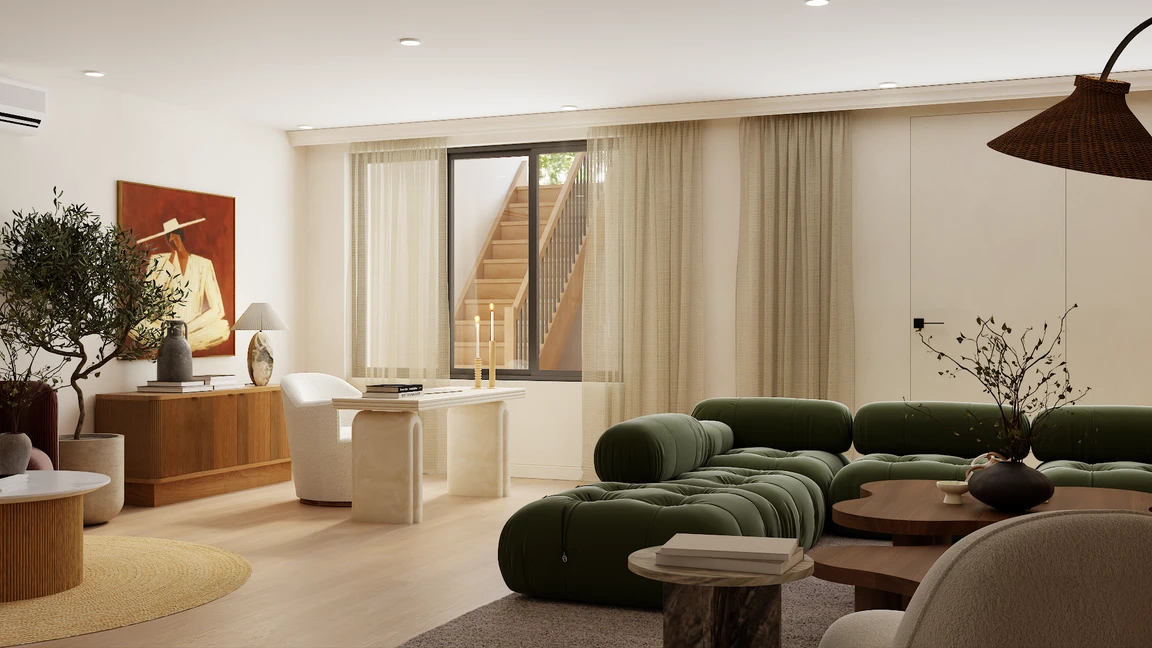 Open plan room with stone leg desk, cream boucle chairs and forest green modular sofa