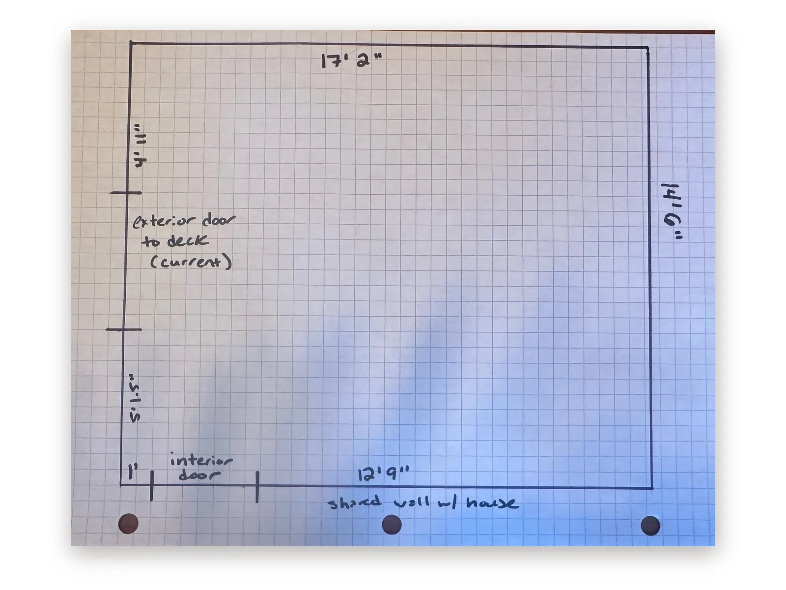 Hand-drawn sunroom floor sketch on graph paper marking an exterior door, an interior door and the shared wall with the house