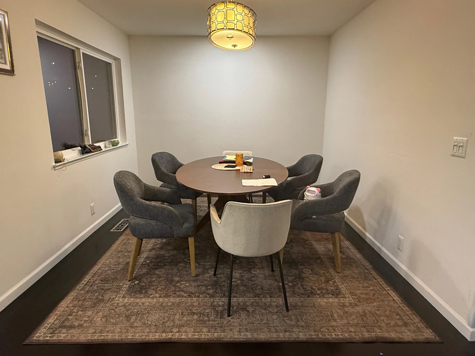 Existing dark dining nook with a round table before the kitchen redesign