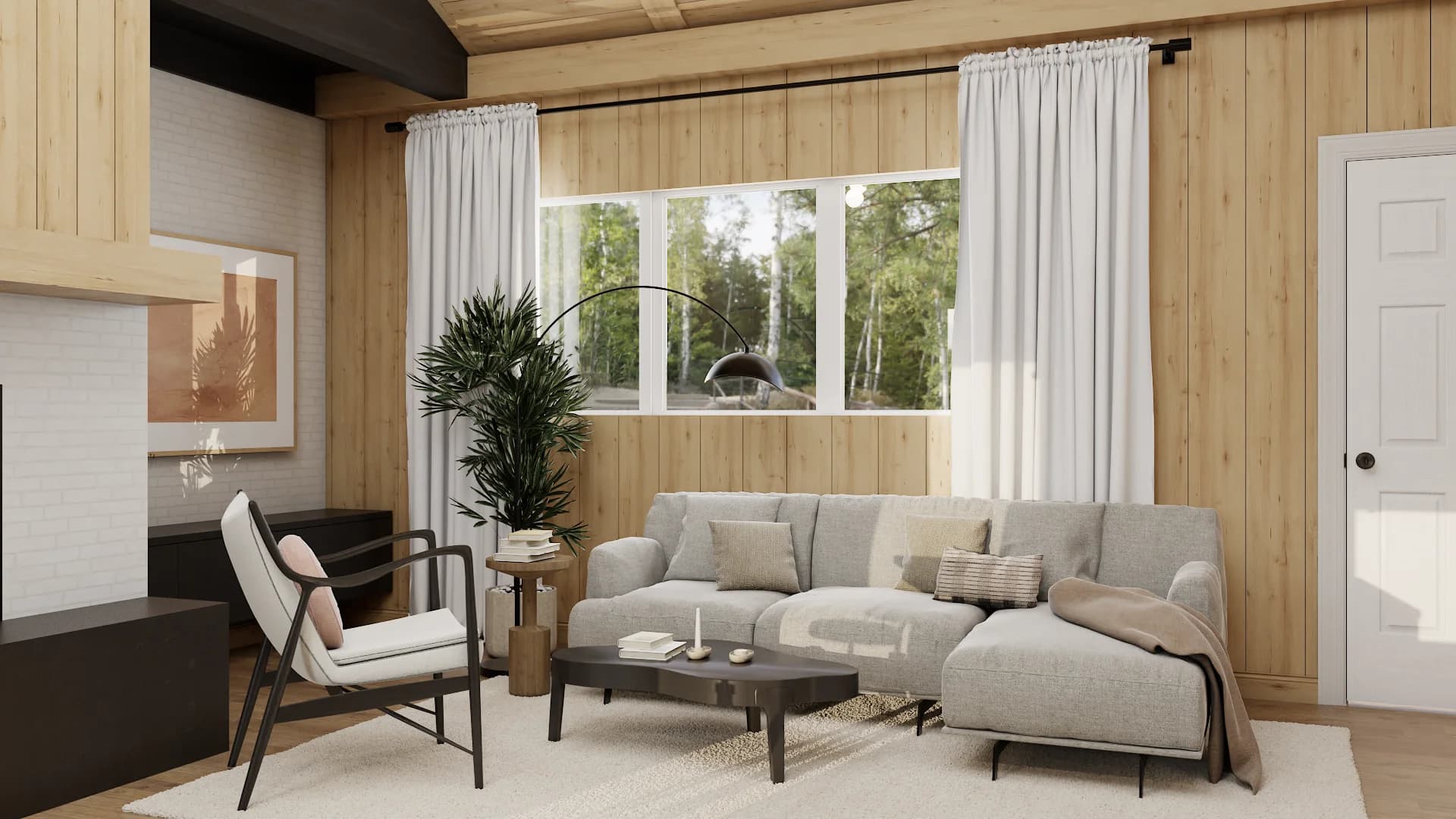 Wood-paneled cabin living room with gray L-shaped sectional, arc lamp, and forest window view