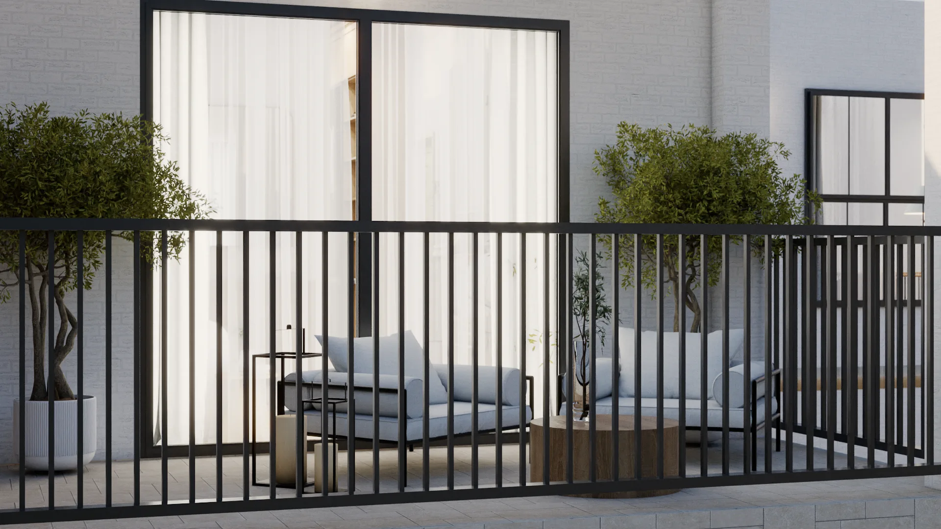 Close-up of lounge chairs through black metal railing with olive tree planters