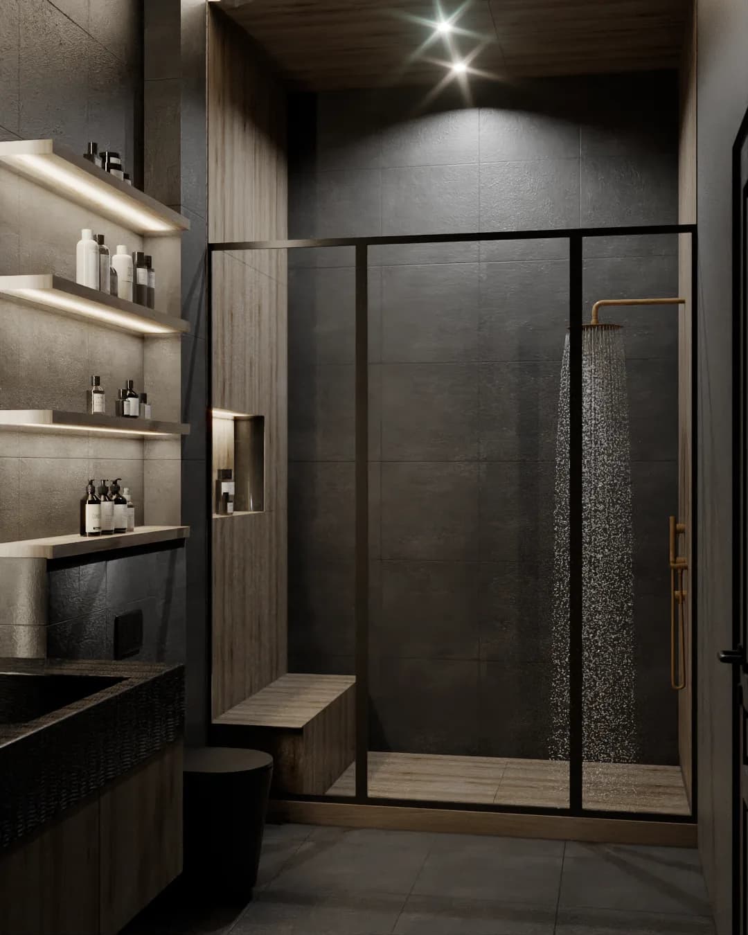 Dark charcoal tile bathroom with brass rain shower, warm wood paneling, and illuminated open shelving with matte black stone sink