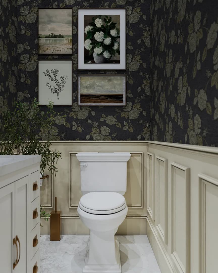 Toilet wall with dark botanical wallpaper and four framed prints above wainscoting