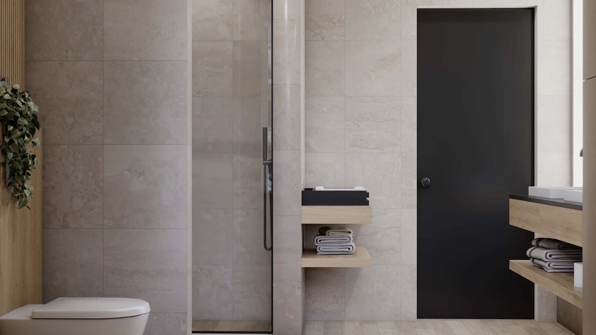 Walk-in shower enclosed by frameless glass partition with slim black handle, floor-to-ceiling limestone tile surround, wall-hung toilet visible on left with wood slat accent wall, two floating oak shelves holding folded towels and a black tray