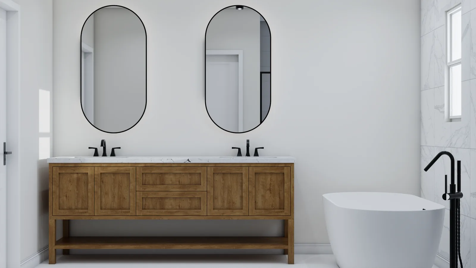 White marble bathroom with oak vanity, dual oval mirrors, brass wall sconces, and freestanding soaking tub