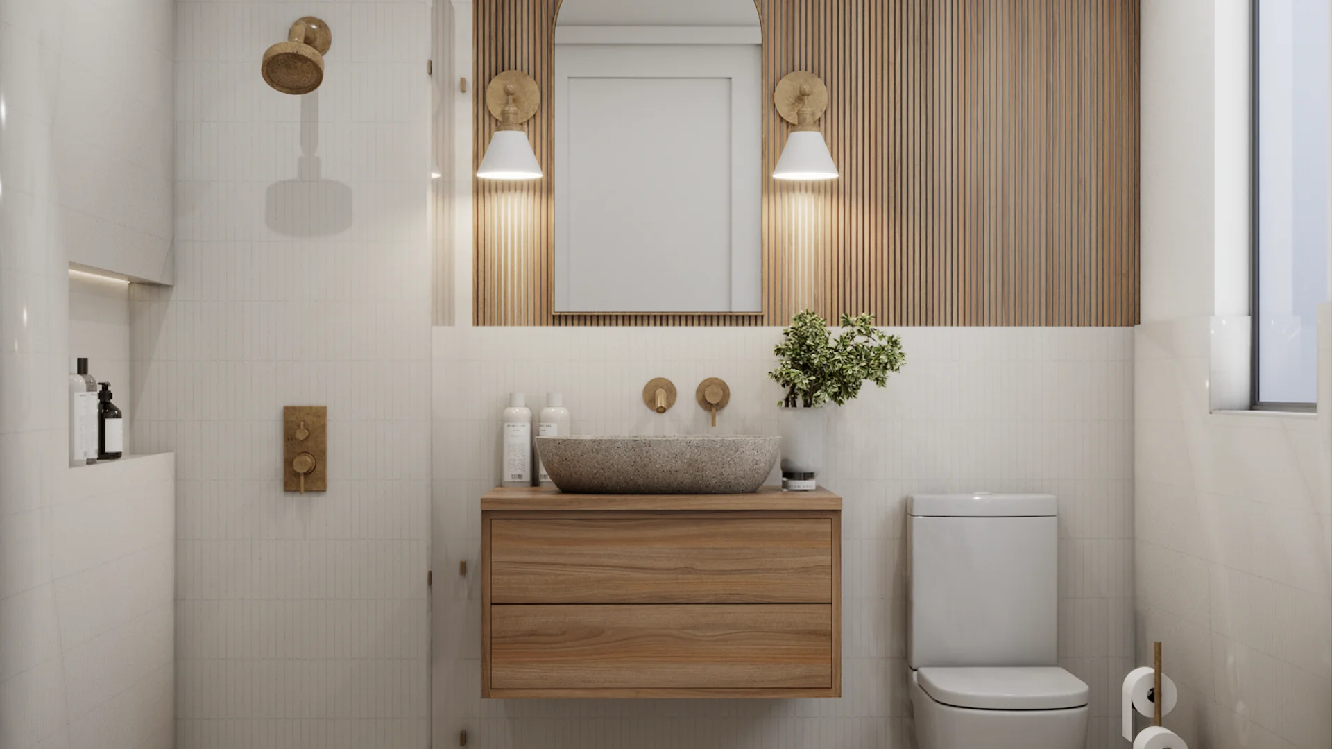 Floating oak vanity with stone vessel sink, brass sconces, and wood slat mirror panel