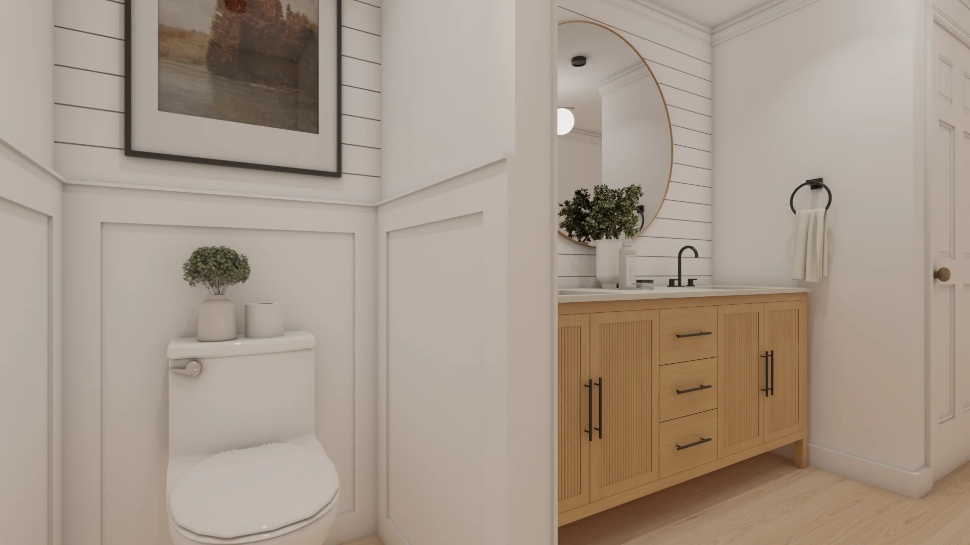 Wainscoted toilet alcove with panel molding, landscape art, and fluted vanity glimpse