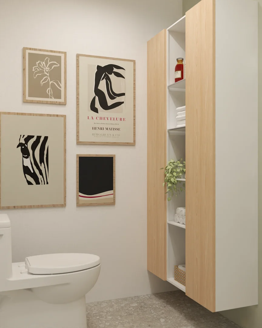 Tall light oak 2-bay storage cabinet beside a framed gallery wall in a small white bathroom.