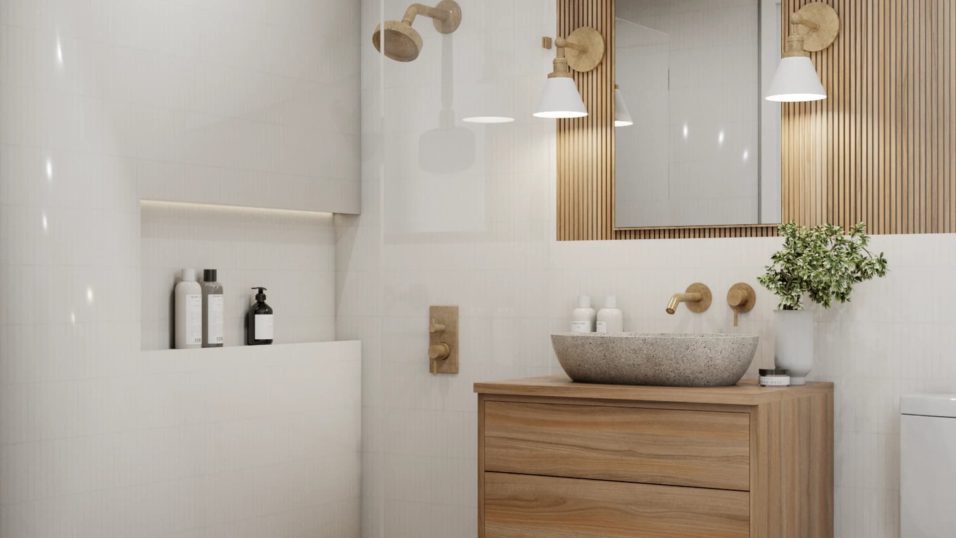 Compact bathroom with floating oak vanity, stone vessel sink, brushed brass faucet, and white cone pendant lights