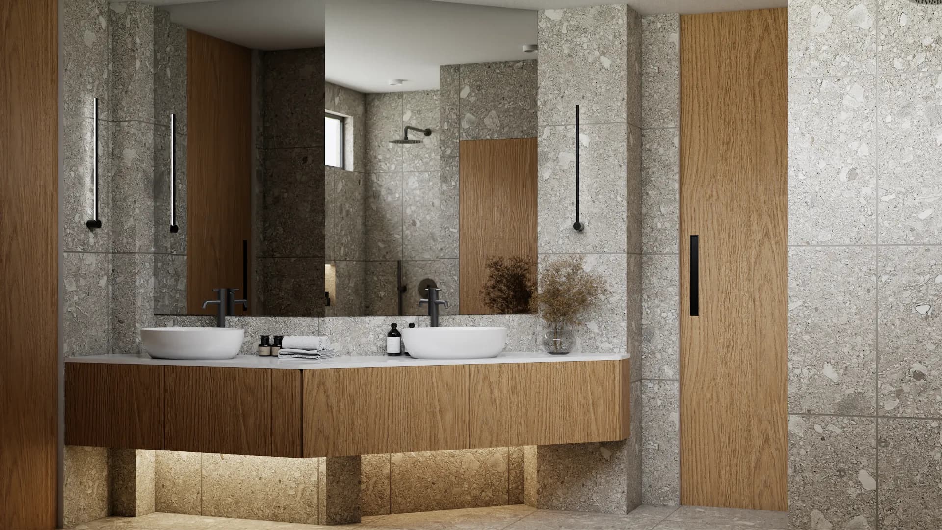 Double oak floating vanity with dual vessel sinks, black sconce lighting, and terrazzo tile walls with under-cabinet LED