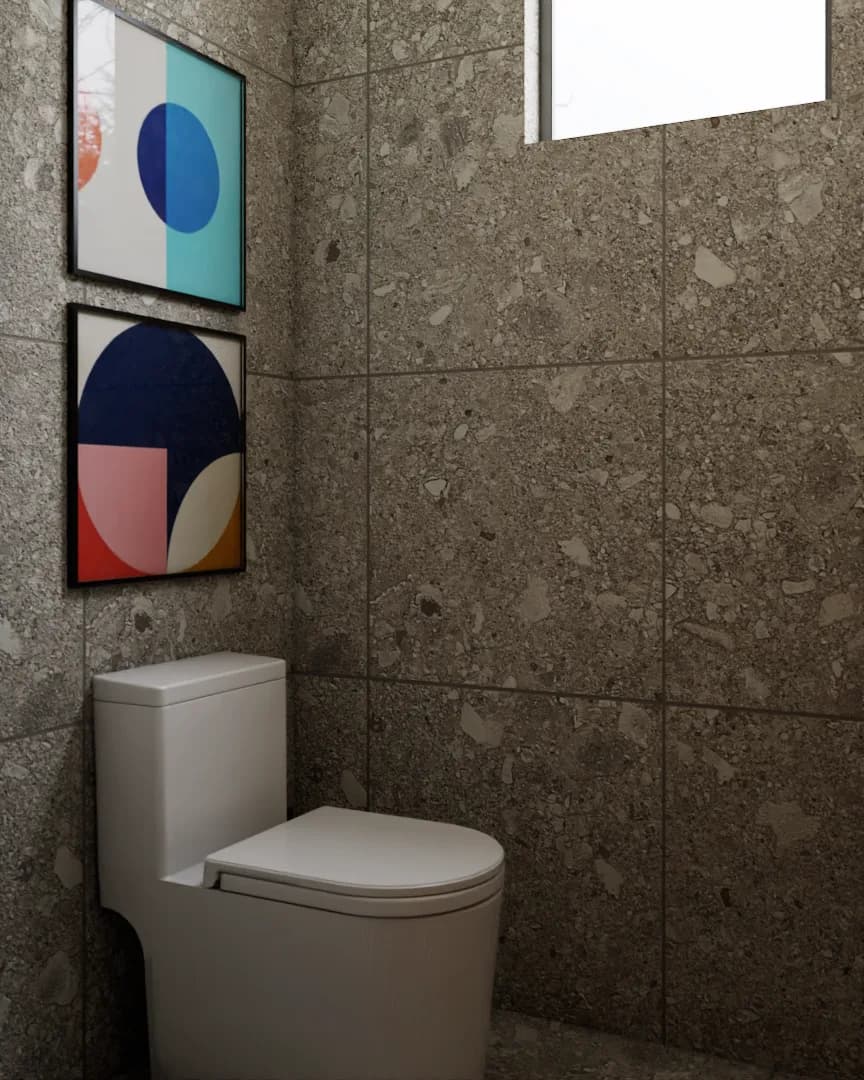 Toilet alcove with terrazzo tile walls, window, and geometric art prints