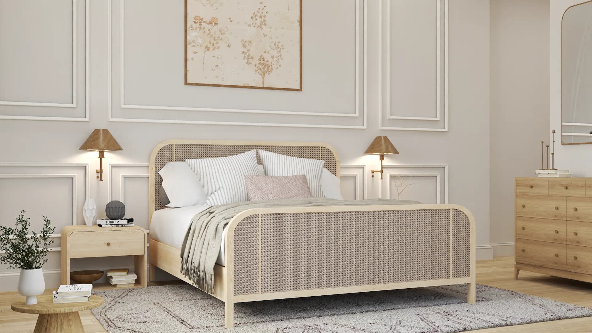 Angled view of cane bed with oak nightstand, brass wall lamp, and botanical art