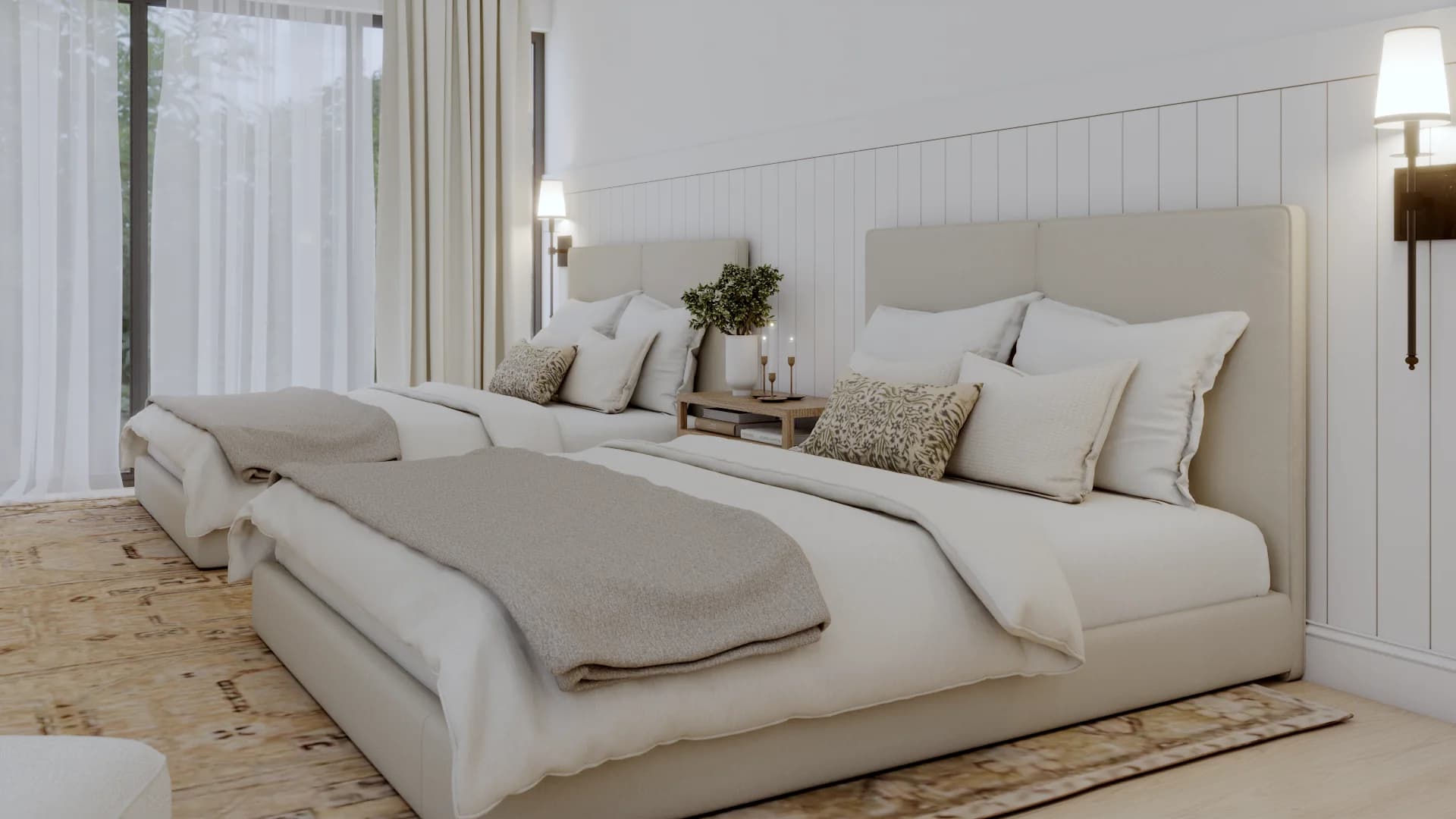 Close-up of two cream upholstered beds against white shiplap accent wall, rattan nightstand between, botanical accent pillows, and sheer curtains