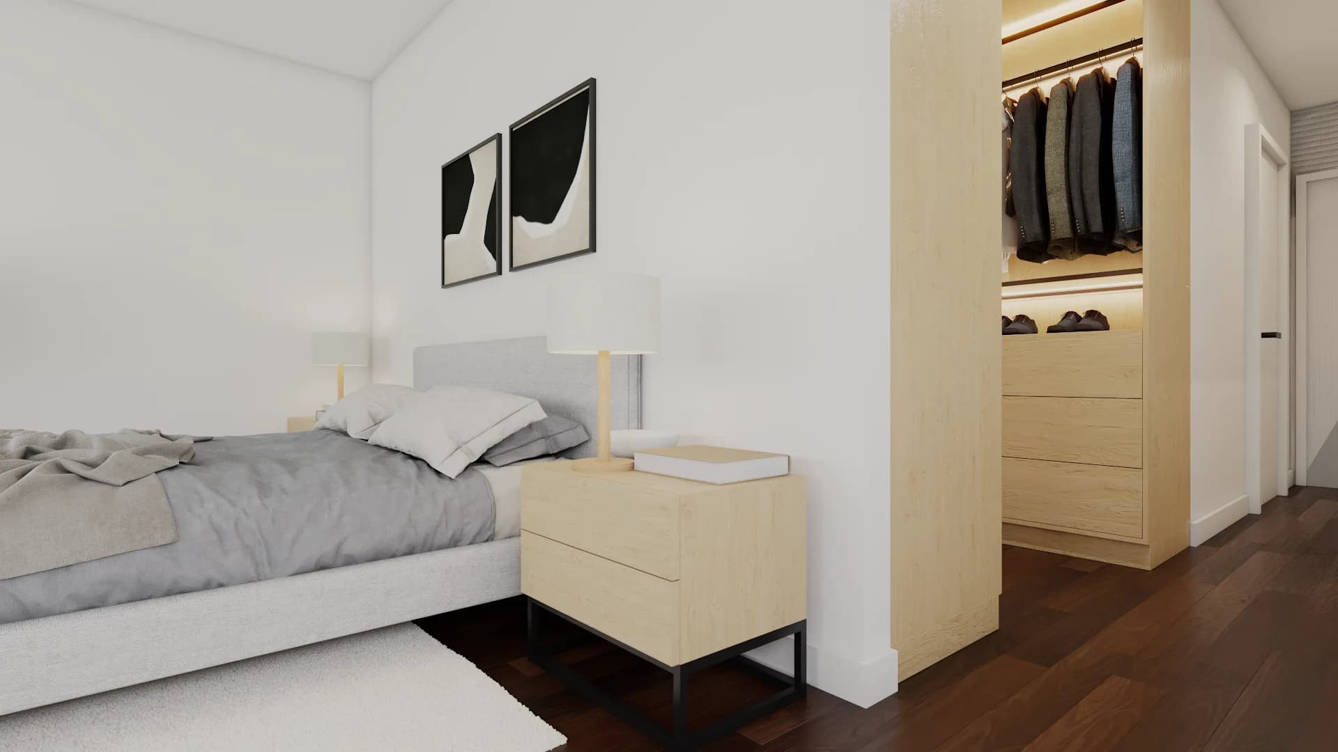 Close angle of bed with gray linen bedding, oak nightstand, and walk-in closet corridor visible thro