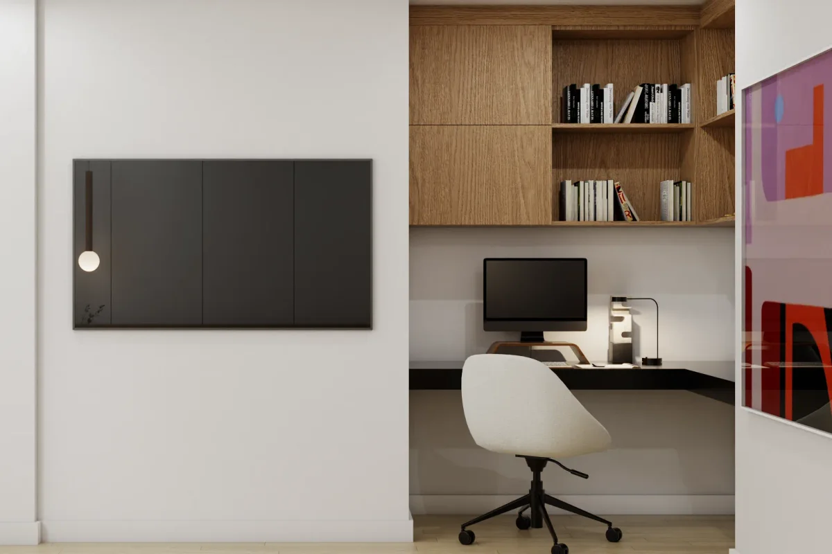 Recessed home office alcove with oak upper cabinets and open shelving above a wide white built-in desk with desktop monitor, white shell chair, and dark mirror panel on hallway wall