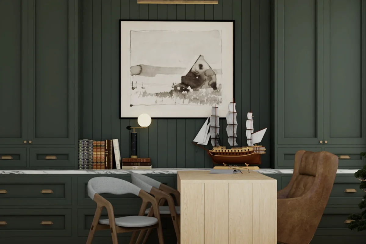 Forest green paneled office walls with floor-to-ceiling green cabinetry and brass drawer pulls, white marble countertop, oak island desk and leather chairs in foreground