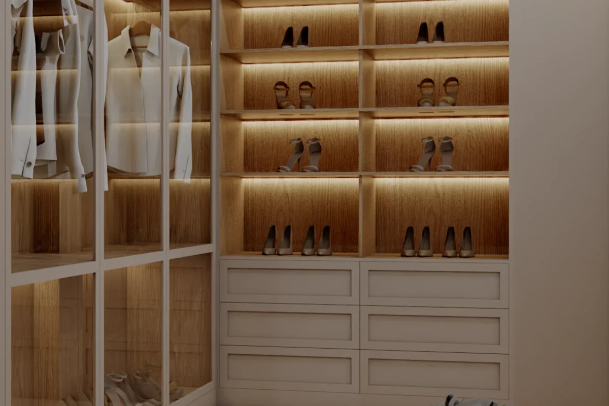 Floor-to-ceiling oak shoe wall with individual LED-backlit compartments, glass-front hanging garment wardrobe on the left, and white shaker drawers at the base