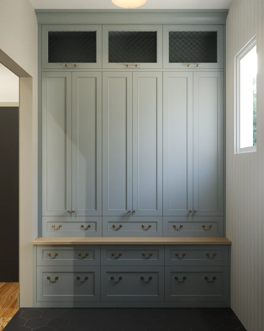 Sage blue-gray shaker mudroom cabinets with wire mesh upper panels, brass bail hardware, and oak butcher block counter