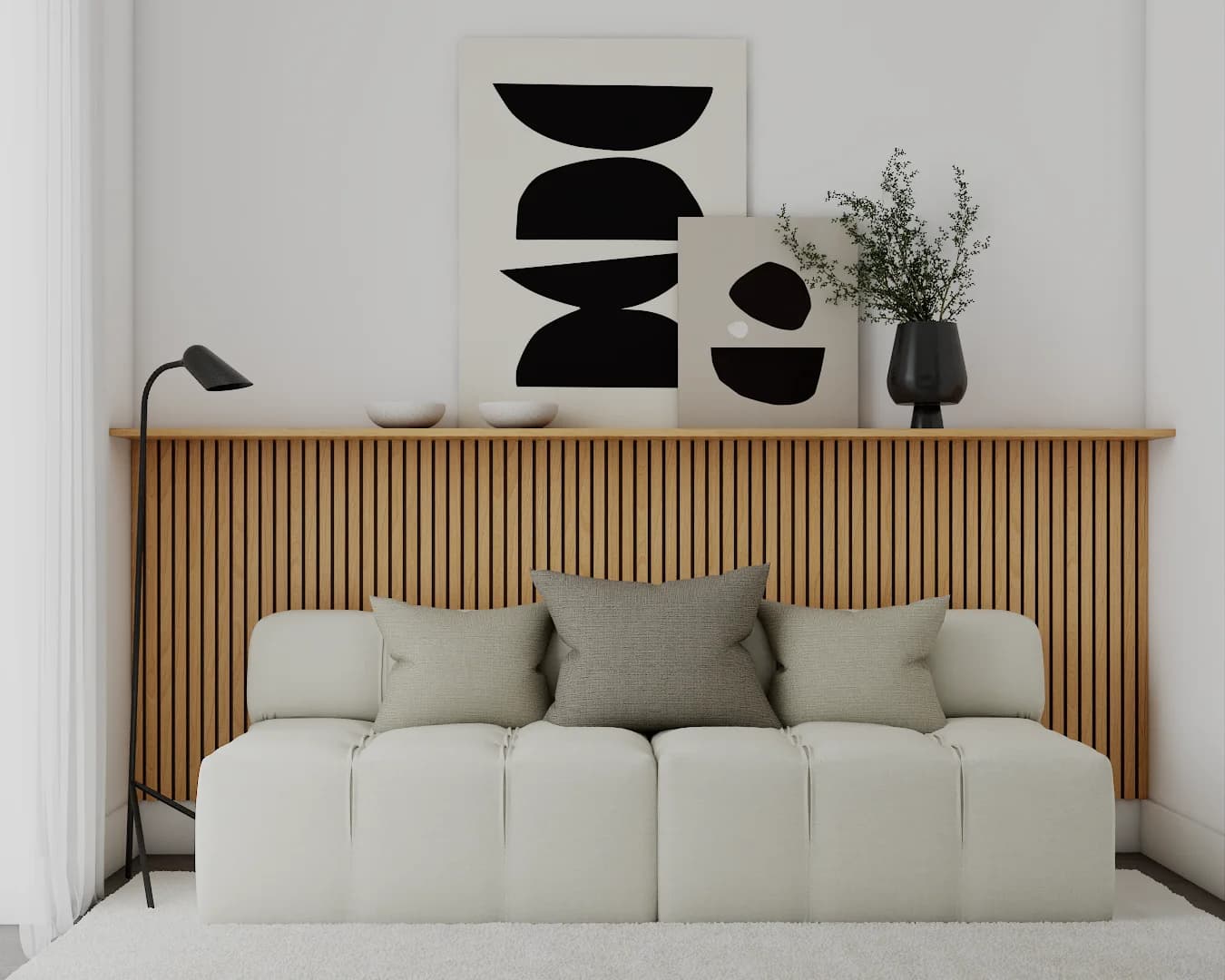 Vertical wood-slat wall with abstract art prints, black accent lamp, and cream bench