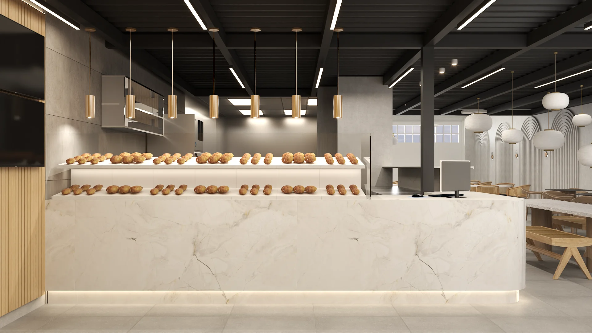 Calacatta marble service counter with two rows of pastries, brass cylinder pendants above, dining area behind