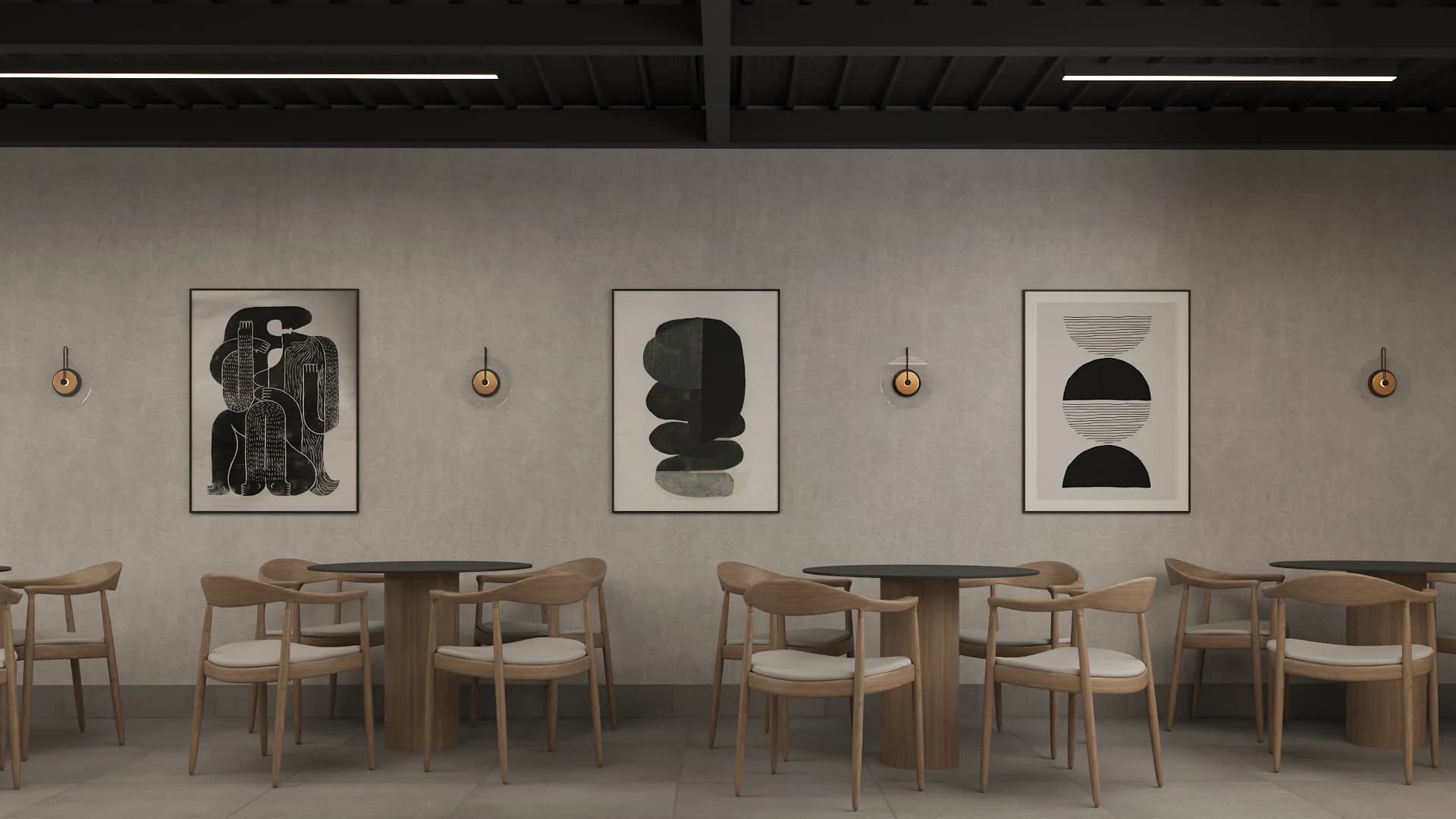 Cafe dining wall with three black abstract framed prints, brass sconces, round oak tables and round-back chairs