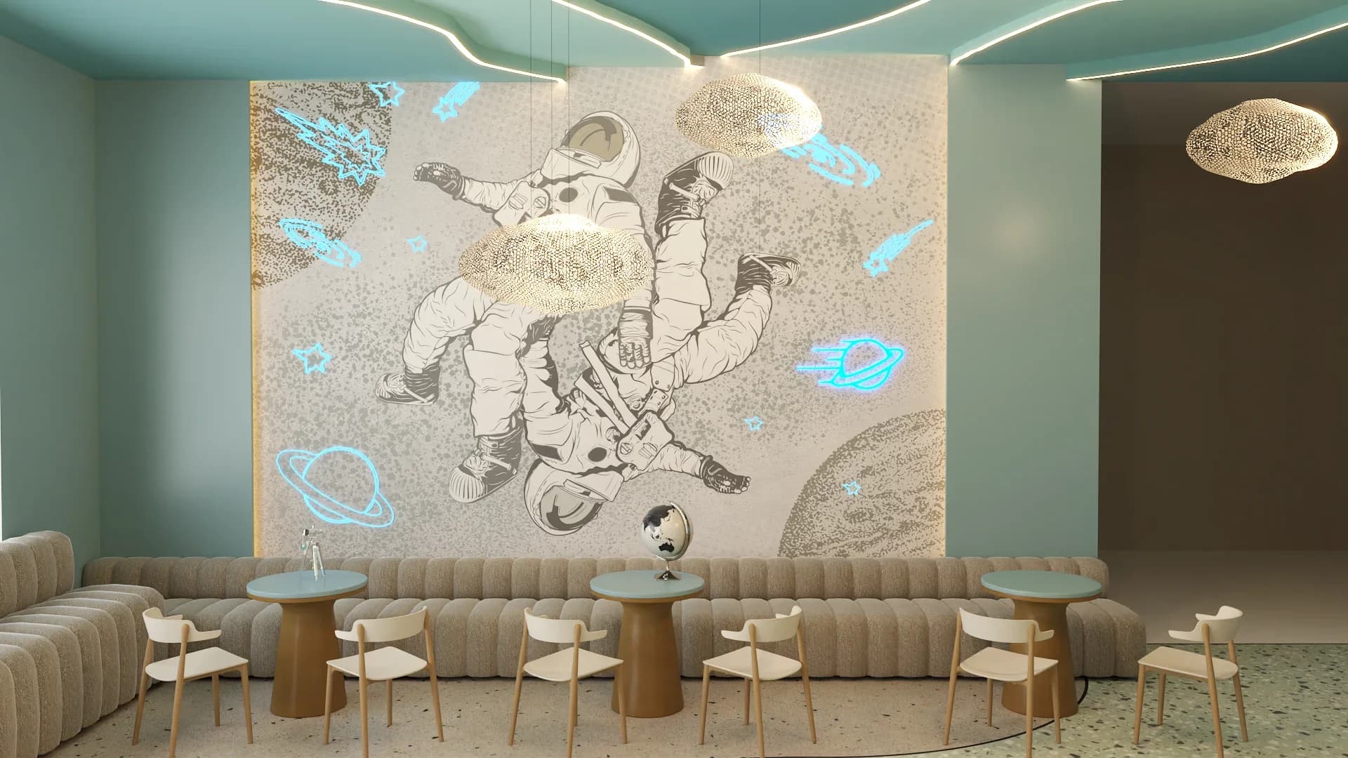 Kids cafe seating nook with a large full-wall astronaut mural in beige and gray tones accented by glowing cyan neon planets and rockets, channel-tufted beige banquette seating below, round wood-top tables with bronze pedestal bases, light wooden chairs, cloud mesh pendant light fixtures, mint green ceiling with wavy white LED strips, and terrazzo flooring