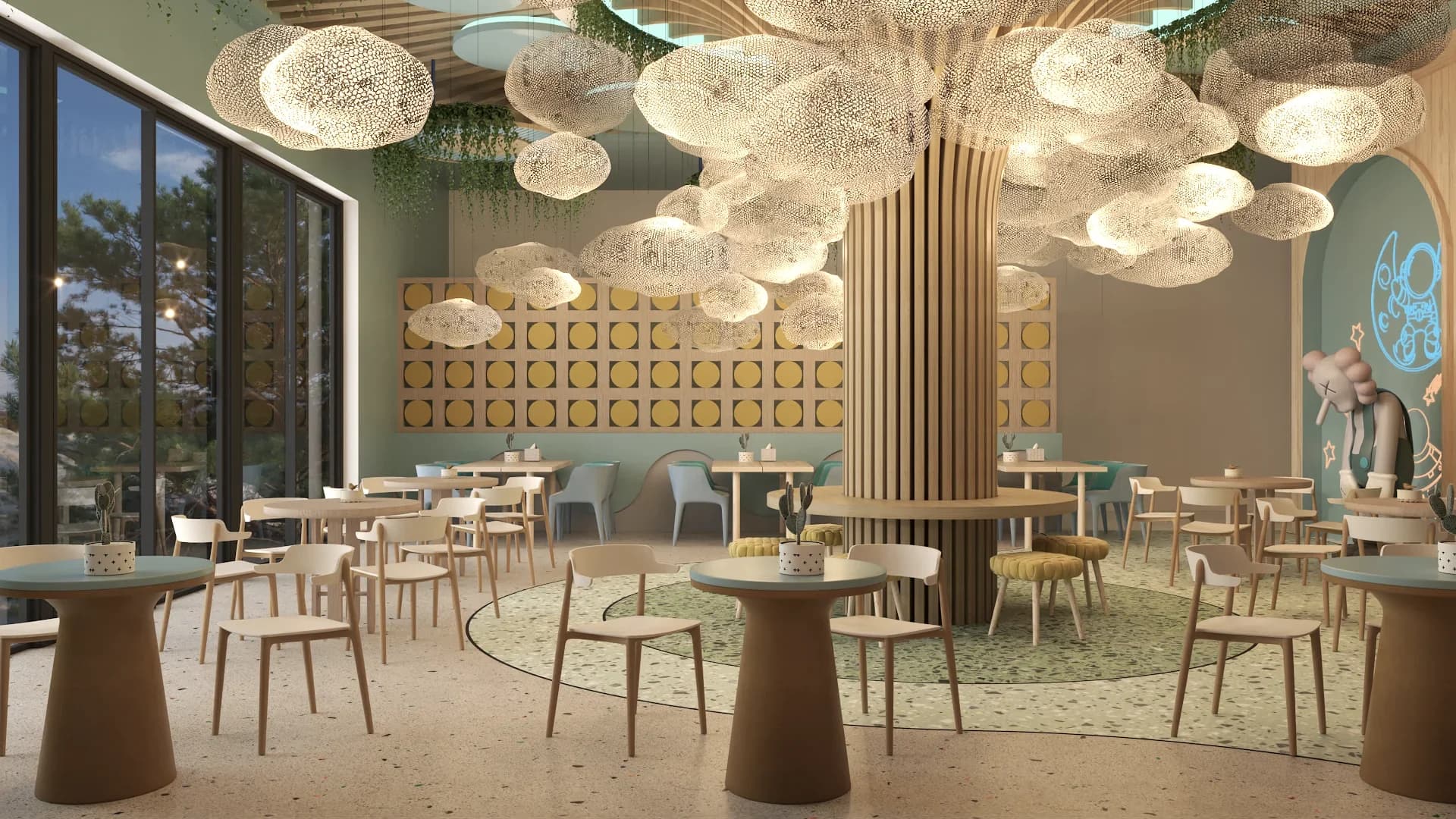 Kids cafe main dining room with a cluster of illuminated cloud-shaped mesh chandeliers suspended from a wooden slat tree-like ceiling structure, terrazzo flooring with a circular green mosaic centerpiece, gold breeze block partition wall, sage green and teal chairs at round wood-top pedestal tables, and a large elephant character sculpture near an arched teal accent wall