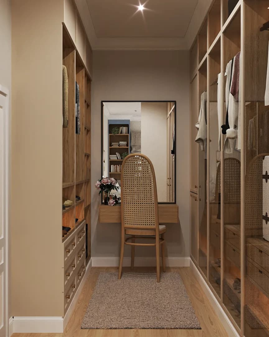 Walk-in closet corridor with open oak shelving on both sides, cane back chair at floating vanity desk, and full-length floor mirror at the far end