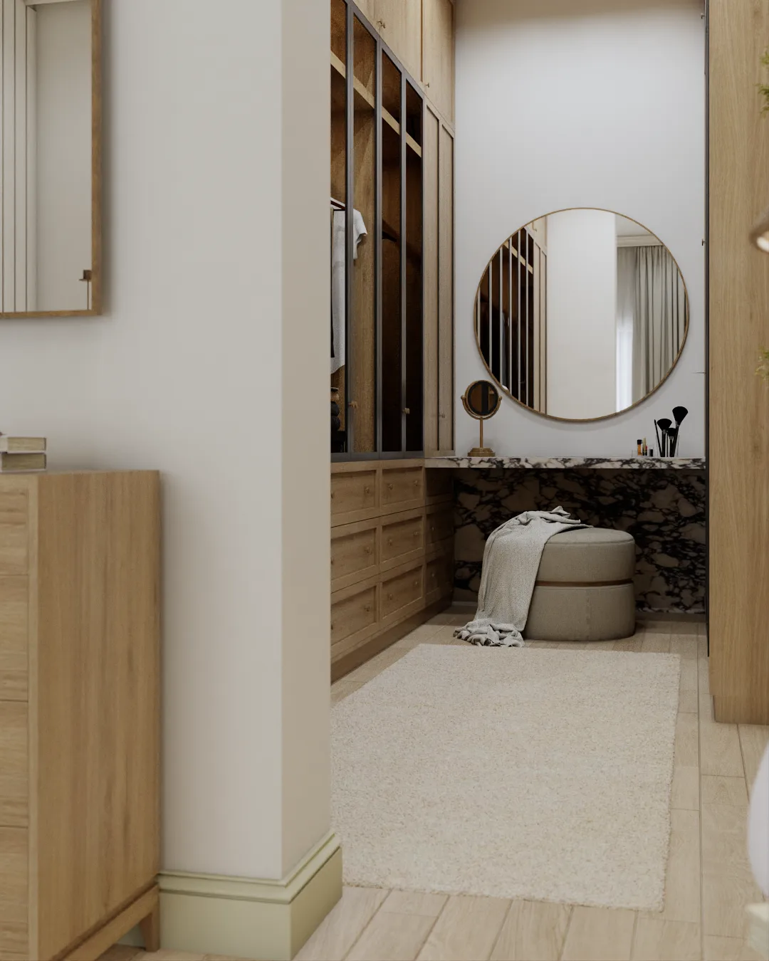 Marble vanity counter with round mirror and oak drawer bank in master walk-in