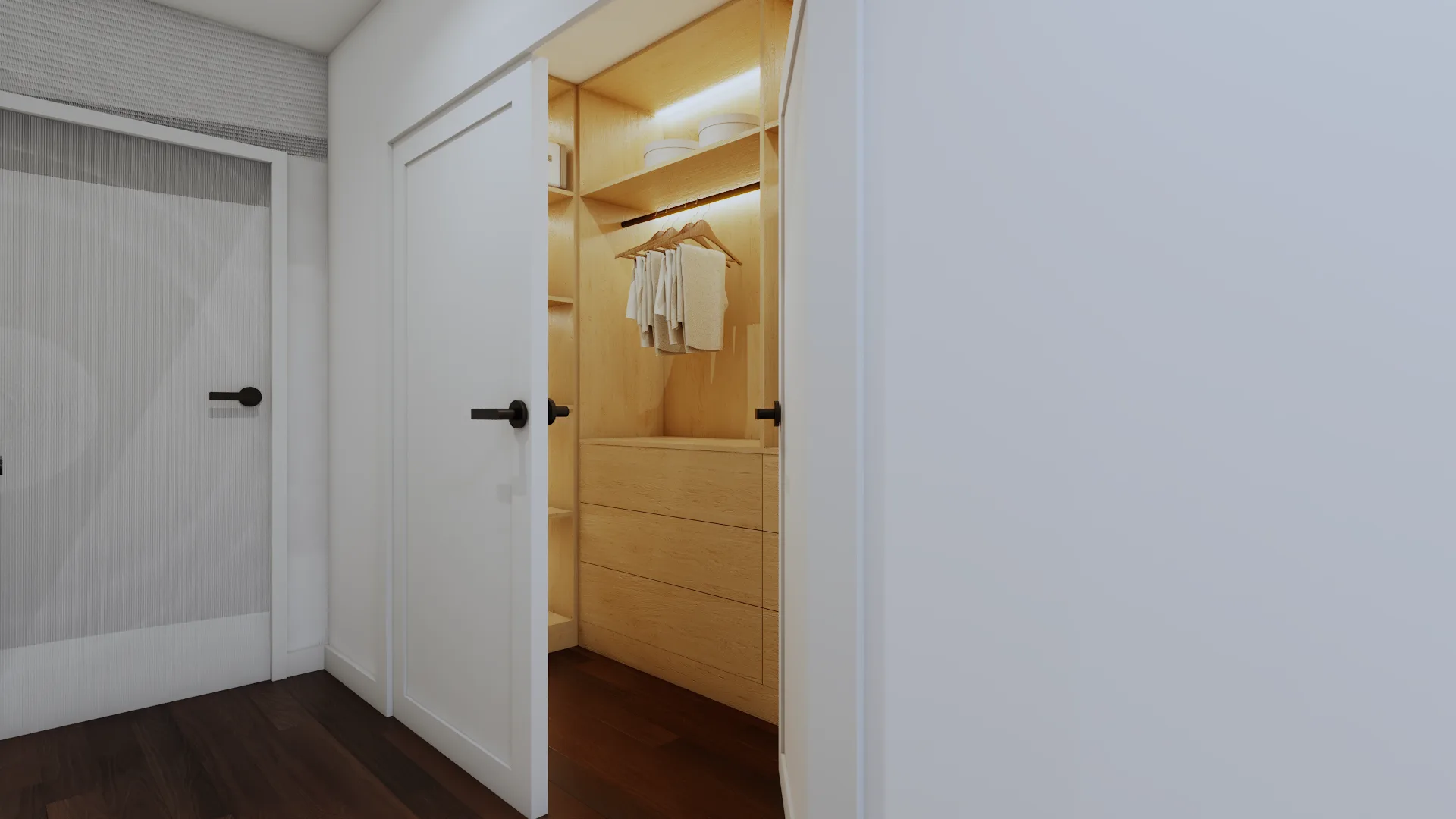 Compact reach-in closet with light oak interior, single hanging rod, floating shelf, three-drawer base unit, LED strip lighting, and white double doors with matte black handles on dark wood hallway floor