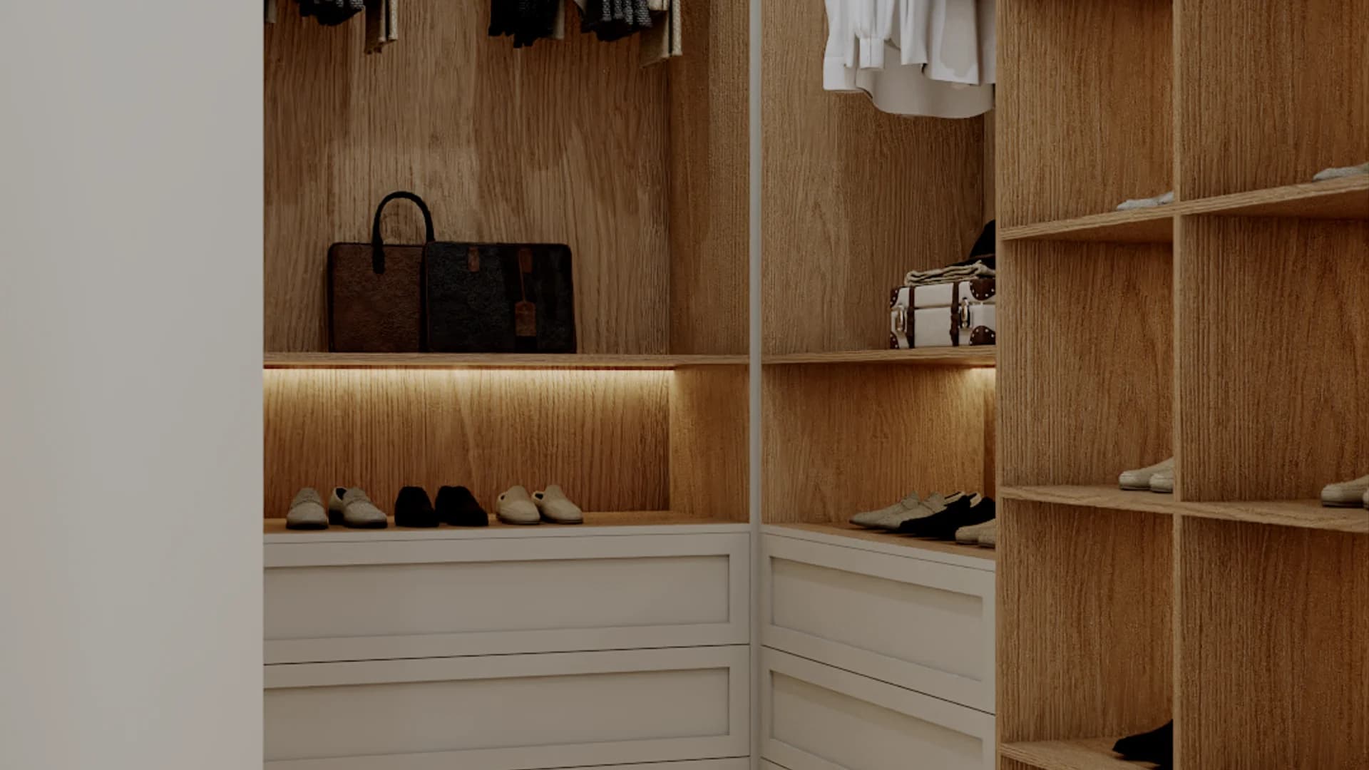 L-shaped closet corner with hanging garments on brass rods, oak cubby shelves for shoes, and LED strip lighting throughout