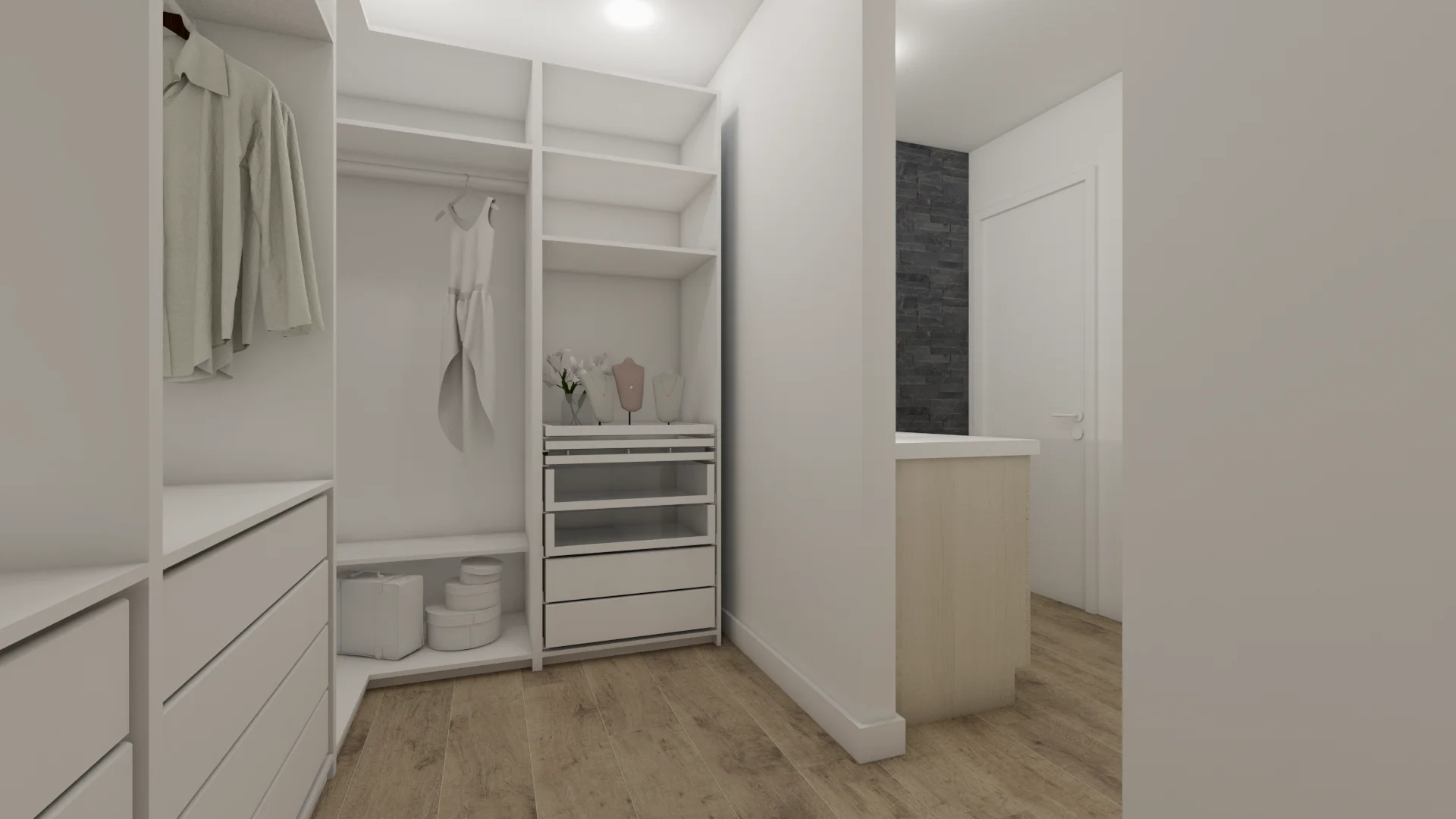 Wide-angle view of white walk-in closet with dual hanging rods, center drawer tower, open display shelves styled with accessories, and charcoal stone wall at the far vanity end