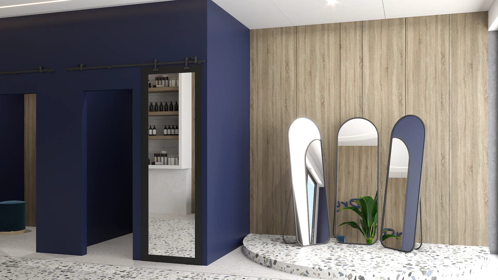 Three arched freestanding mirrors on terrazzo platform beside navy barn door fitting room entrance