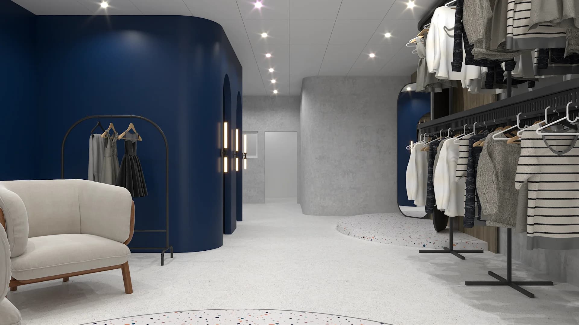 Wide view of back zone with navy arched fitting rooms, garment racks, and cream boucle armchair
