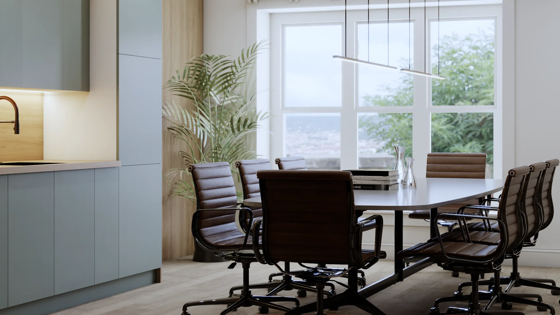 Blue-grey flat-panel lower cabinets with integrated matte black faucet and warm oak countertop on the left, large floor-to-ceiling window with city and tree views filling the back wall, single thin linear LED pendant above the table, white oval conference table surrounded by brown leather executive chairs