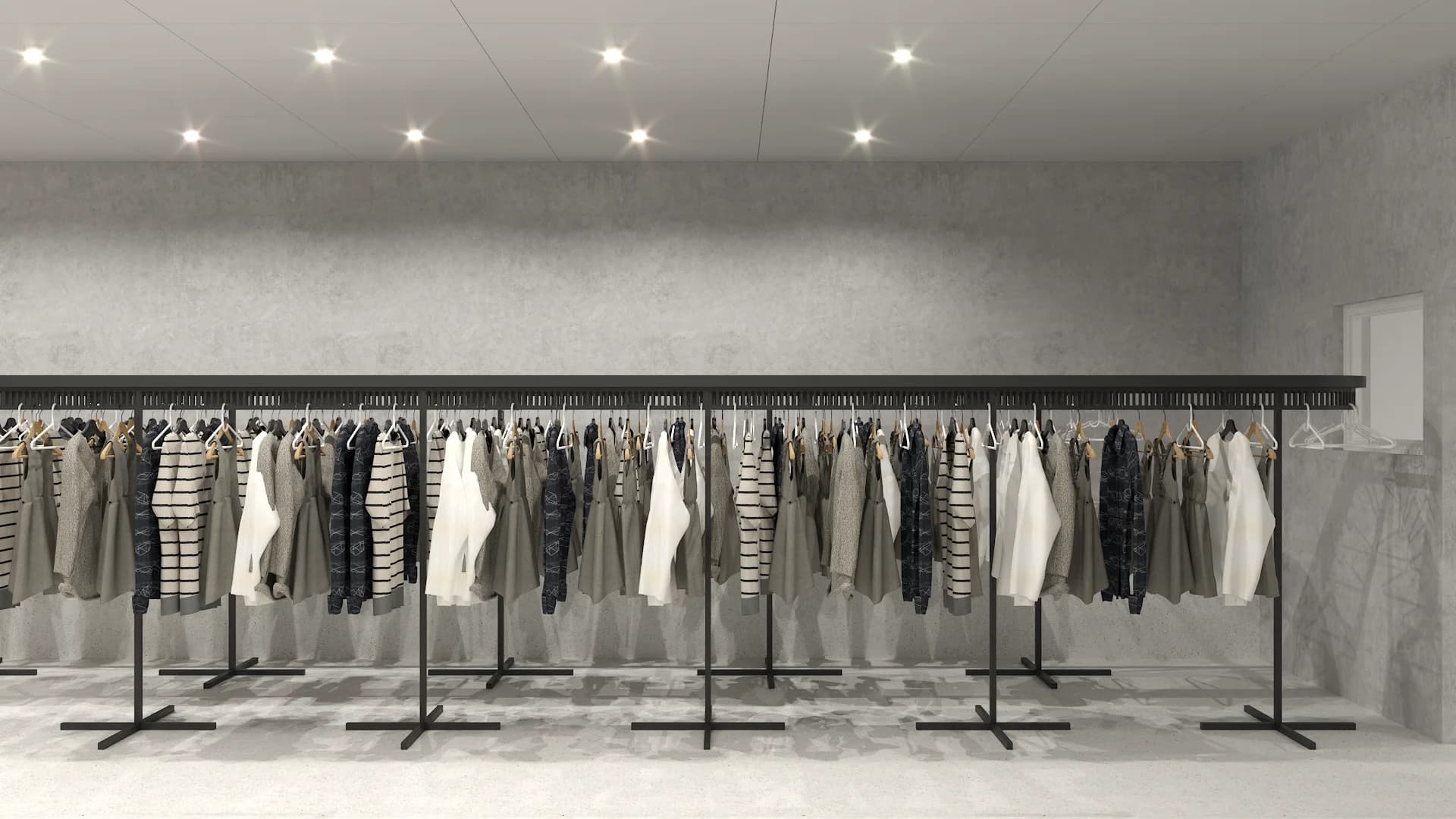 Frontal view of double-tier garment racks on concrete wall under recessed ceiling spotlights