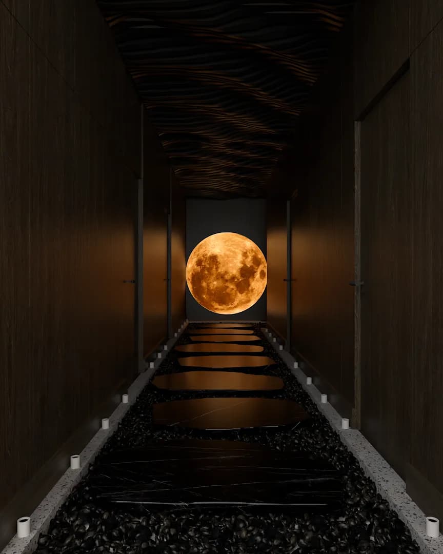 Dark spa corridor with amber moon sculpture at end, wave-texture ceiling, river rock borders and stepping stones