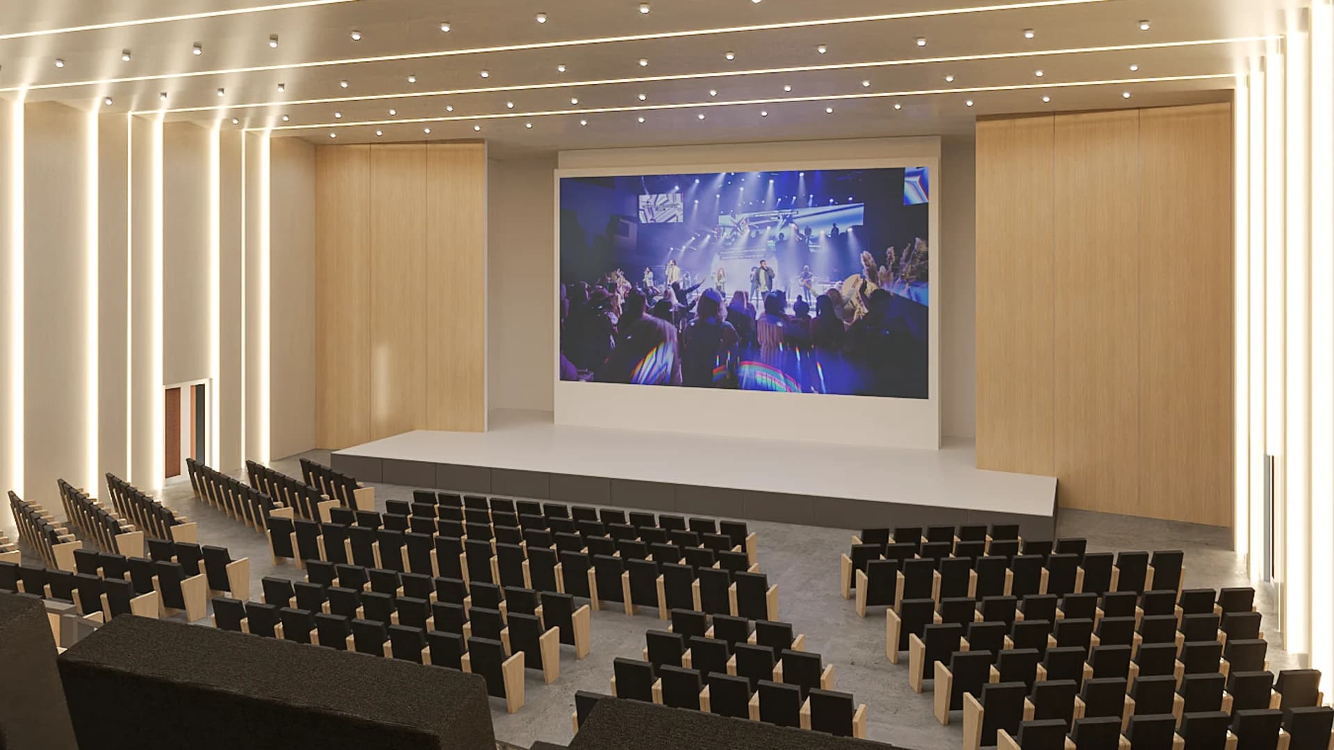 Corporate auditorium with tiered seating, wood panel walls, LED display screen, and linear lighting
