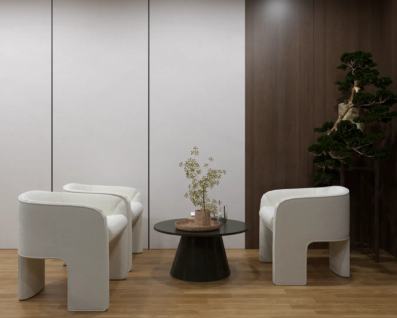 Office sitting area with two white lounge chairs, black round table, and bonsai tree