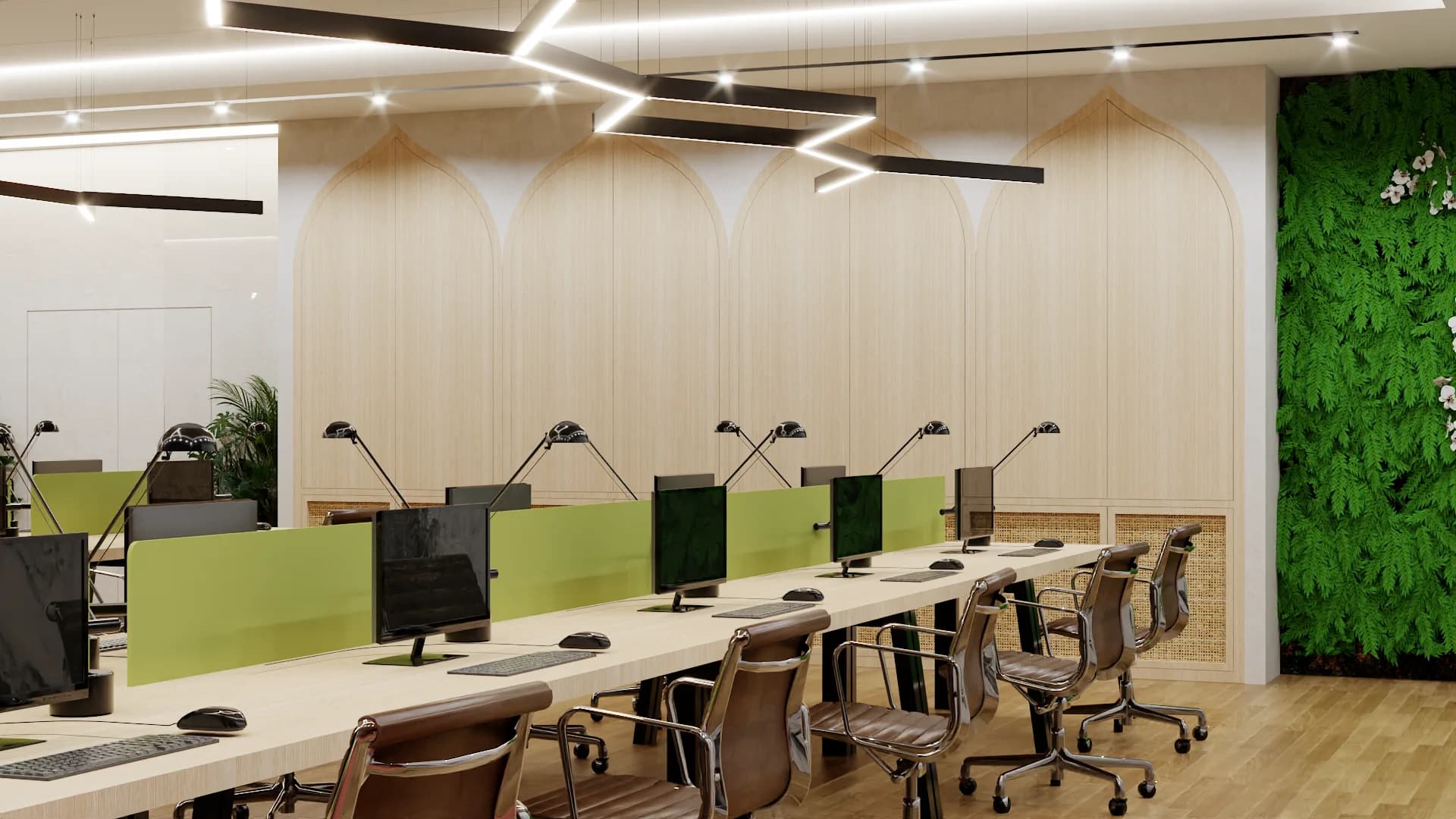 Open office workstations with green privacy panels, task lamps, and living plant wall