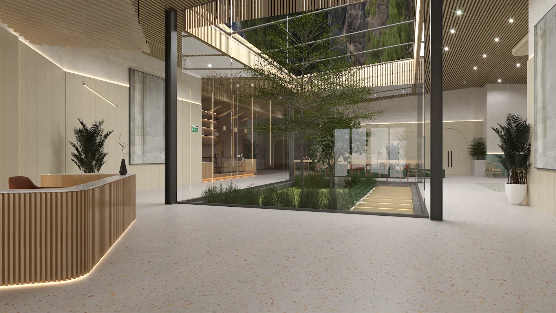 Reception area looking toward glass-enclosed atrium with large indoor tree and water feature