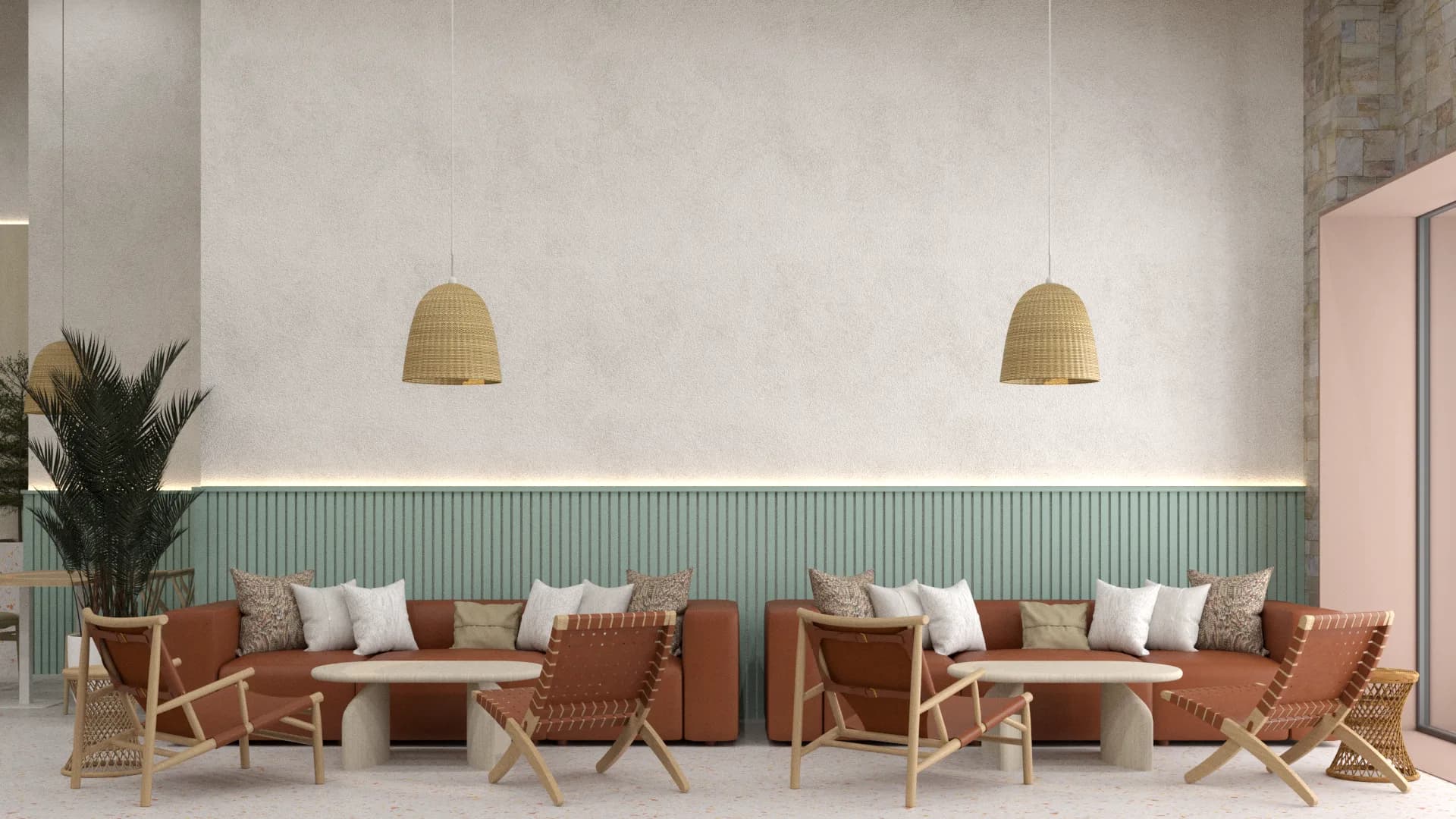 Symmetrical cognac leather sofas with paired rattan pendants against sage wainscoting wall