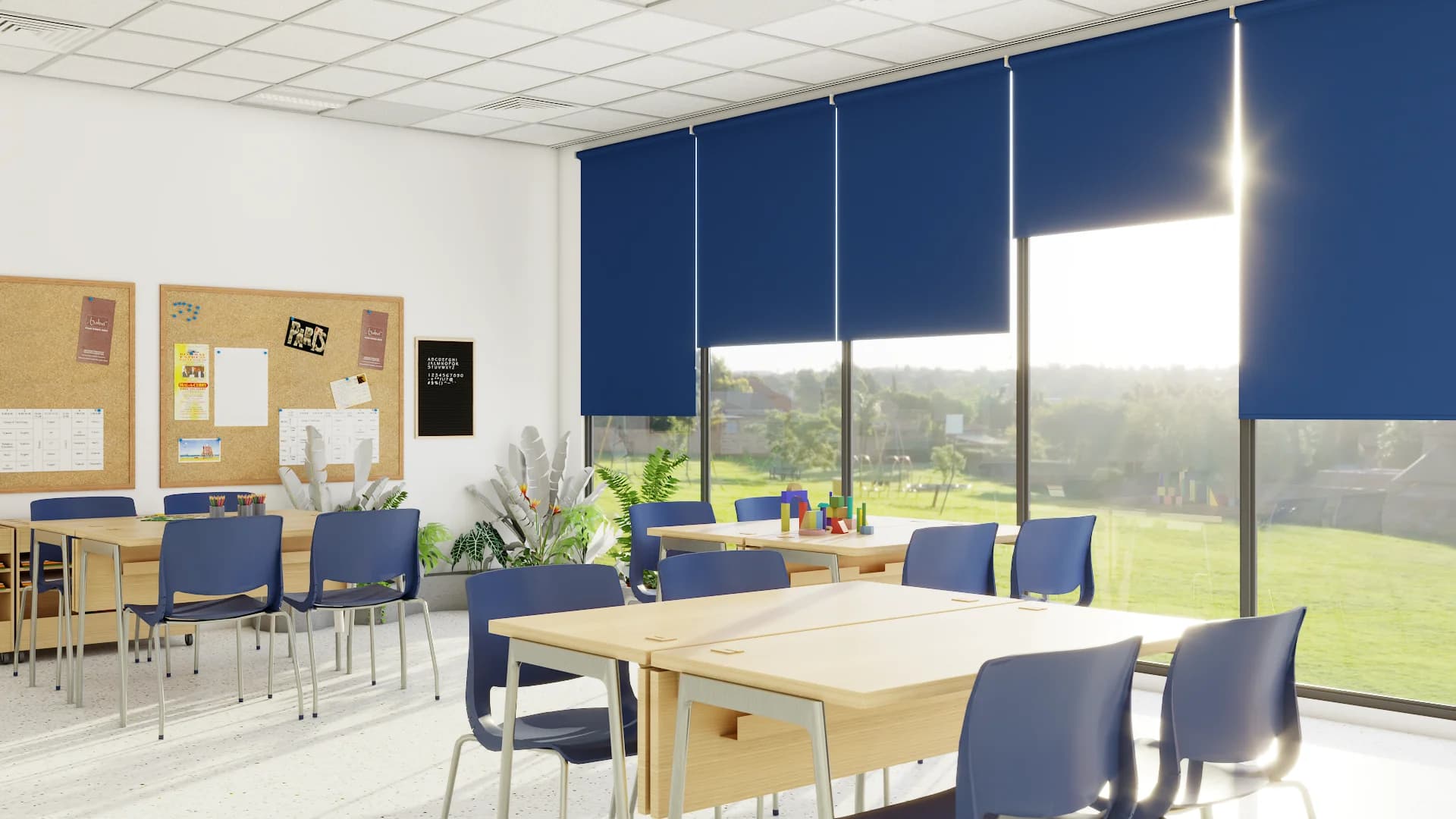 Corporate training room with navy roller shades, maple tables, blue chairs, and cork boards