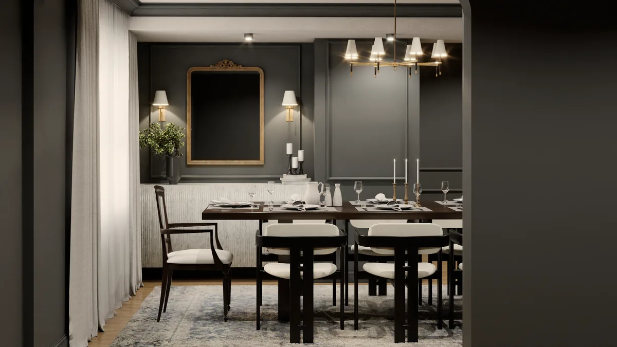 Through-doorway view of charcoal dining room with gold mirror, brass sconces, and walnut table