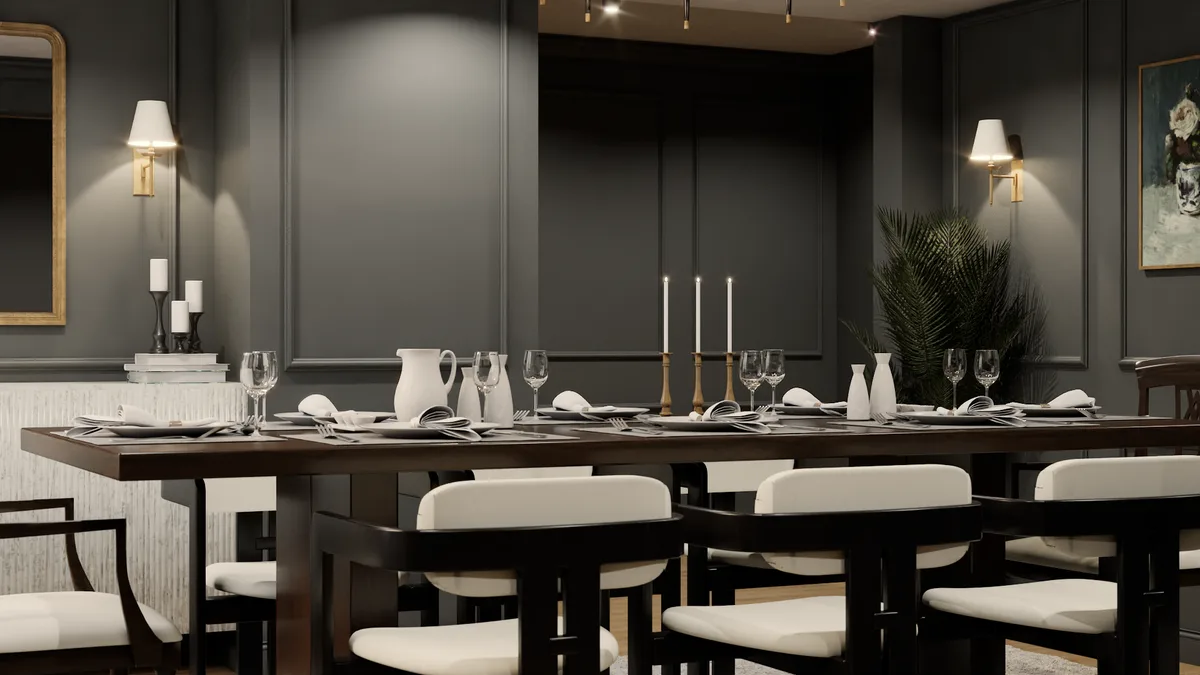 Close view of walnut table with cream napkins, crystal glassware, brass candleholders, and ceramic pitcher