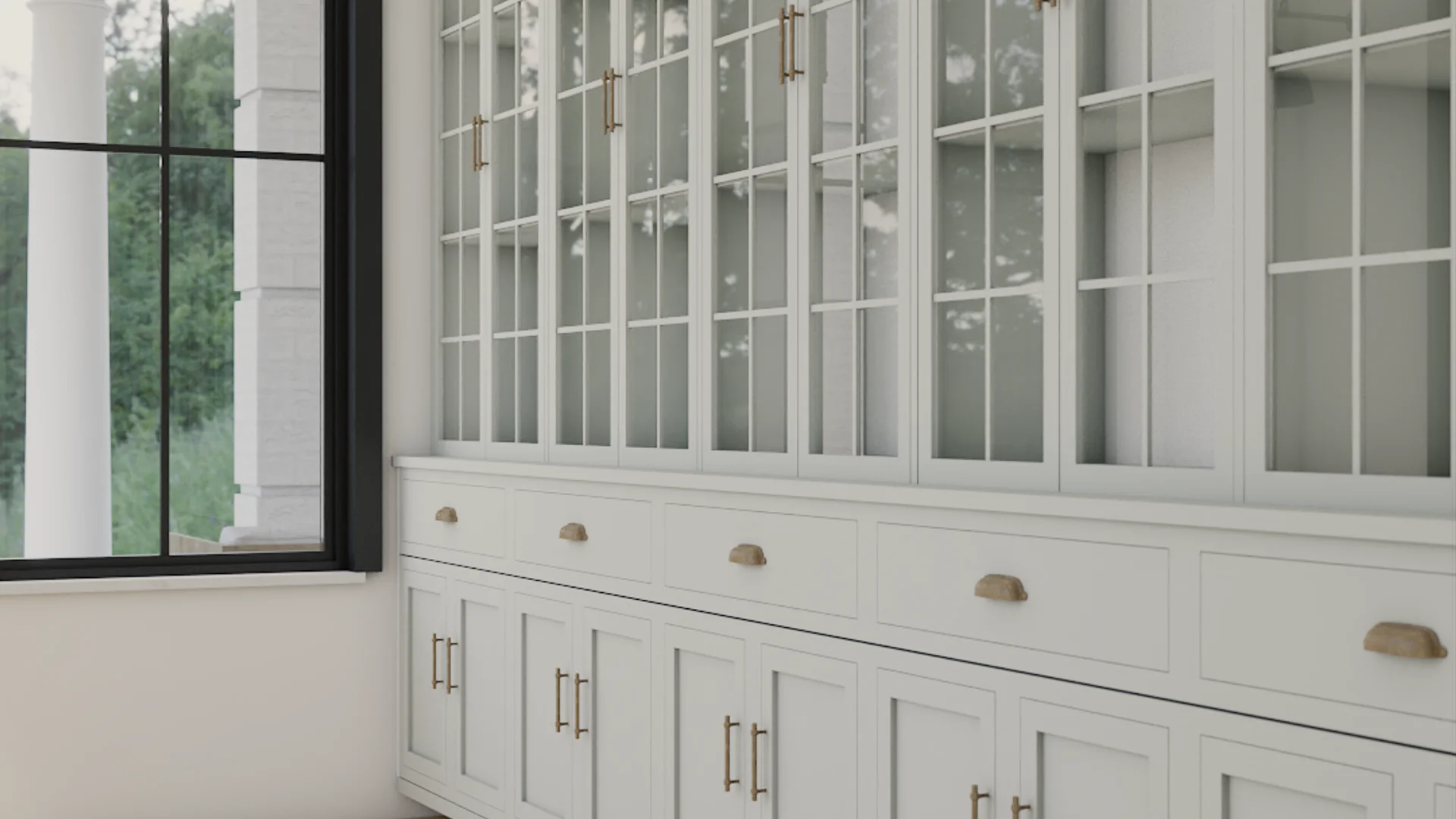 Close-up of white glass-front china hutch with brass bar and cup pull hardware, glass shelving visible through mullion doors