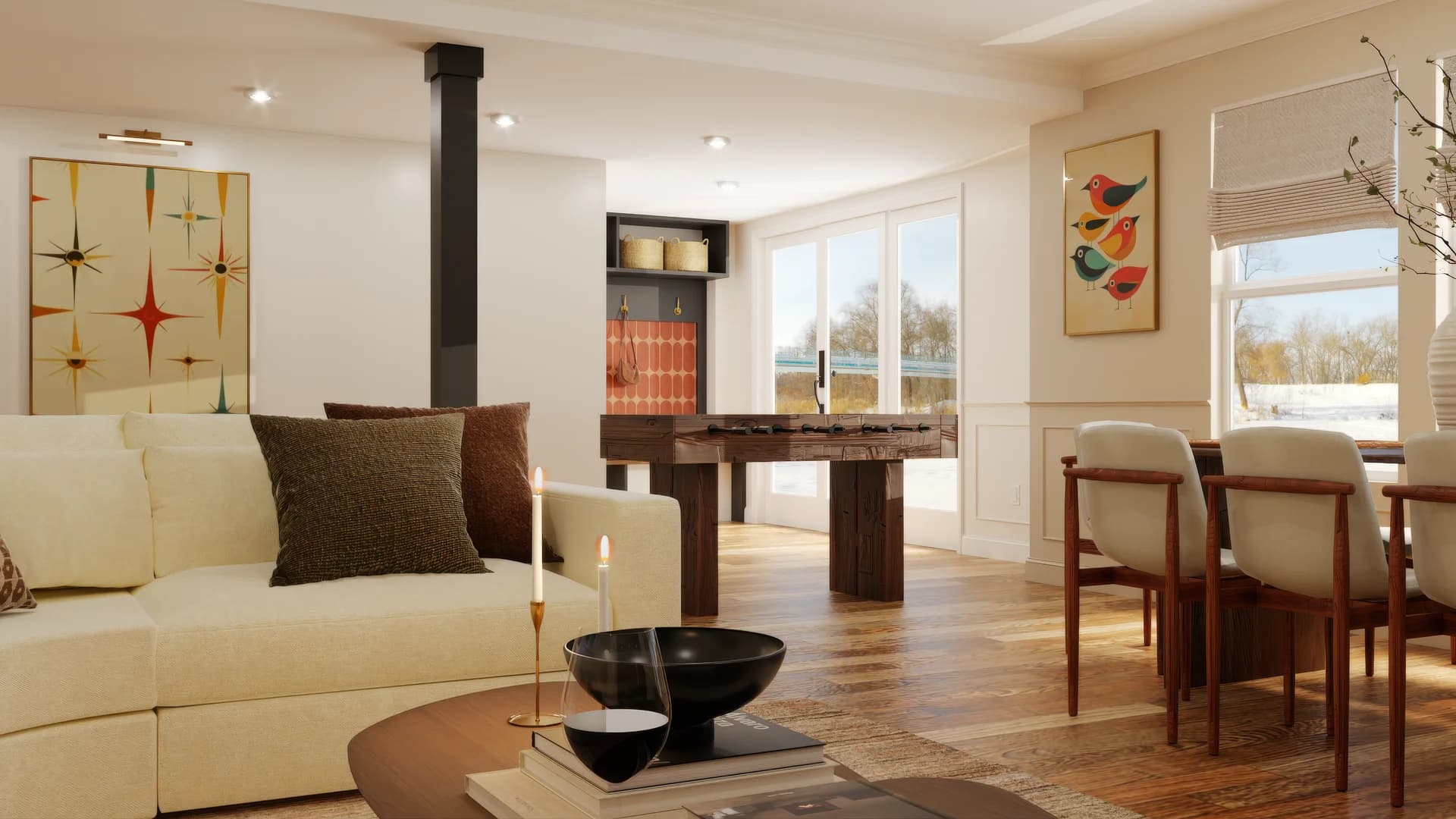 Basement dining area looking back across open plan space with cream sectional, walnut foosball table, midcentury starburst panel art on wall, bird artwork near window, tan dining chairs, walnut dining table, and hardwood floor throughout.