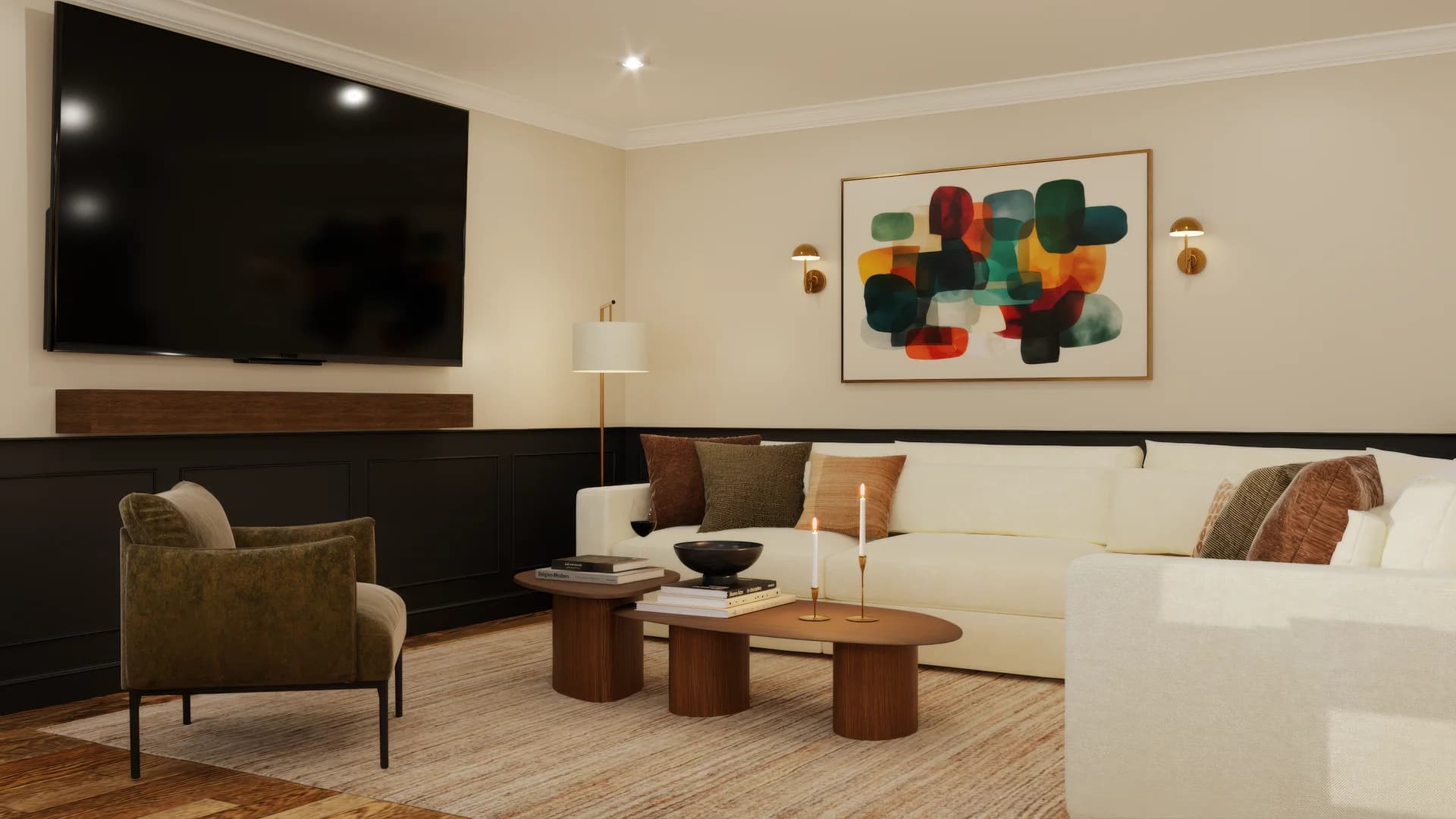Tighter angle of basement lounge showing cream curved sectional with brown and olive throw pillows, walnut nesting coffee tables, candle holders, black bowl, olive accent chair, wall-mounted TV, and abstract multicolor artwork with brass sconces.