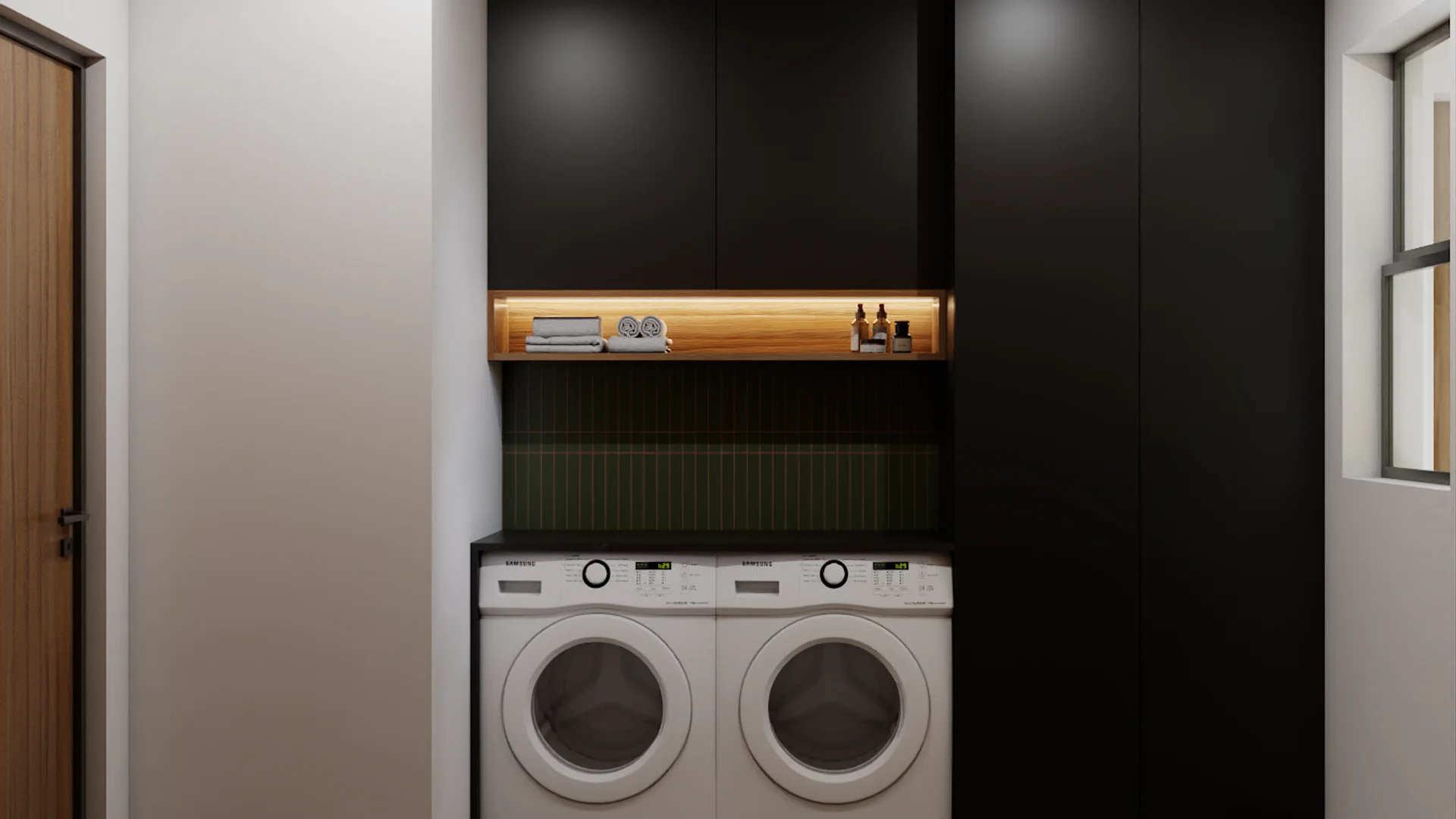 Laundry room with black cabinetry, front-load washer and dryer, green tile backsplash, and LED-lit oak shelf with folded towels