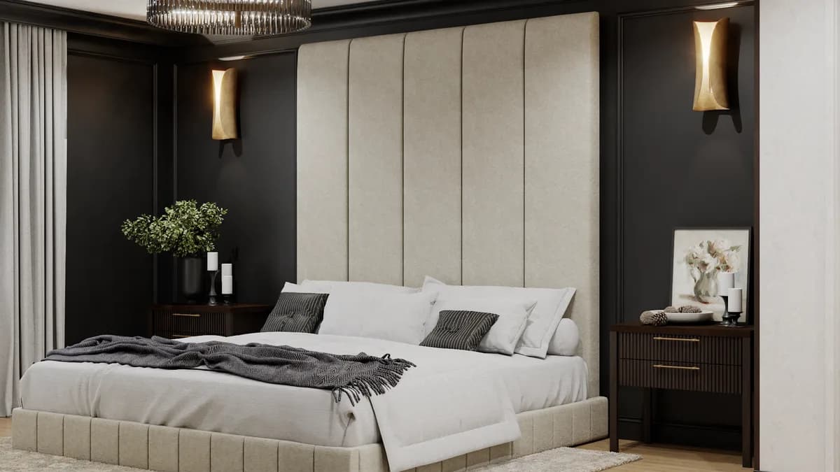 Cream channel headboard closeup with brass sconces against charcoal wall in the bedroom zone